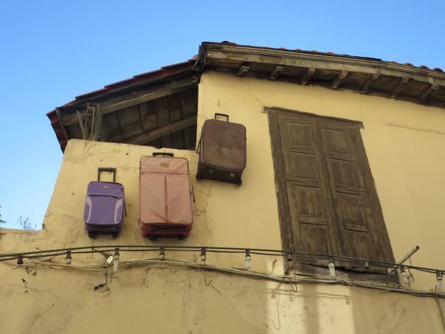 Luggages hanging on a wall!